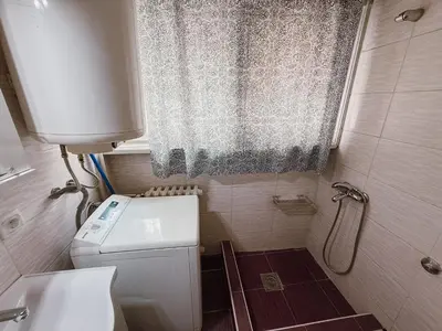a small bathroom with a toilet and a window at Mateja Apartman in Belgrade
