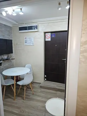 a room with two tables and chairs and a door at Daca 2 in Belgrade