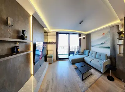a living room with a couch and a tv at Belgrade Waterfront 16th fl Lux Apt. w/ City view in Belgrade