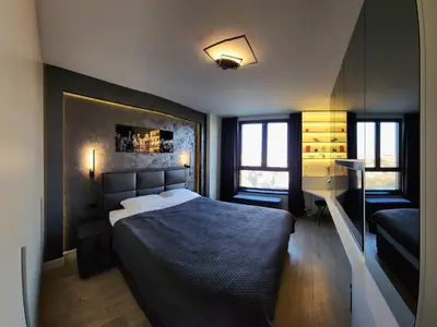 a bedroom with a large bed and a couch at Belgrade Waterfront 16th fl Lux Apt. w/ City view in Belgrade