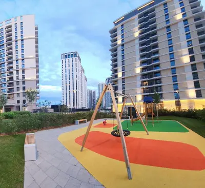 a playground in front of some tall buildings at Belgrade Waterfront 16th fl Lux Apt. w/ City view in Belgrade