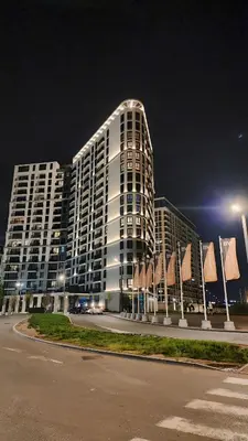 a large white building at night with a street at Belgrade Waterfront 16th fl Lux Apt. w/ City view in Belgrade
