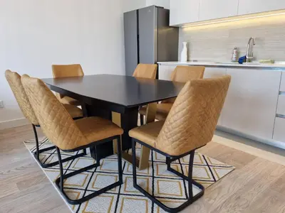 a black dining room table and chairs in a kitchen at BW Aria deluxe apartments in Belgrade