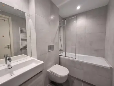a bathroom with a toilet and a sink and a shower at BW Aria deluxe apartments in Belgrade