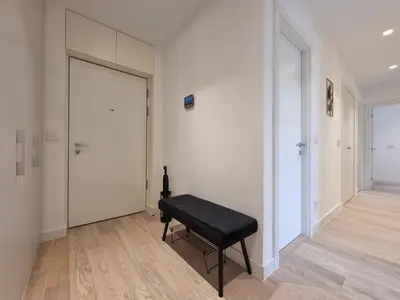a room with a black bench and a door at BW Aria deluxe apartments in Belgrade