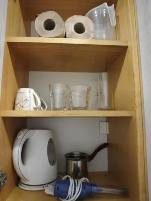 a wooden shelf with a microwave and some paper towels at Dunja Apartmans in Belgrade