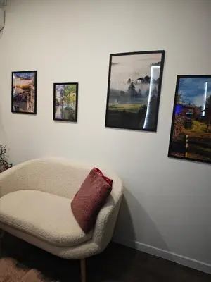 a living room with a couch and pictures on the wall at Dunja Apartmans in Belgrade