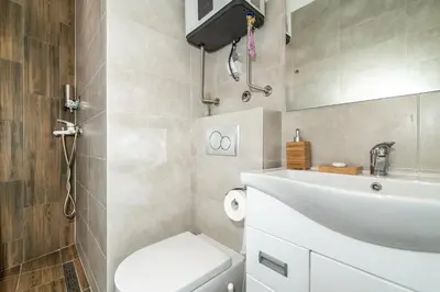 a bathroom with a white sink and a toilet at Luxury Stay in Belgrade Waterfront with Views in Belgrade