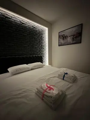 a bedroom with a bed with two towels on it at Modern Luxury in Belgrade Waterfront with Views in Belgrade