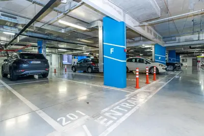 a parking garage with cars parked in it at Modern Luxury in Belgrade Waterfront with Views in Belgrade