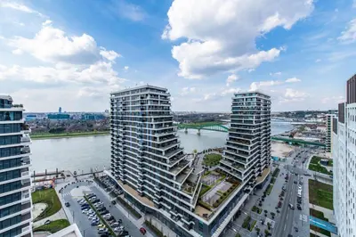 two tall buildings in a city next to a river at Modern Luxury in Belgrade Waterfront with Views in Belgrade