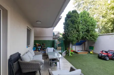 a patio with a couch and a table and a toy car at DULE’S HOUSE in Belgrade
