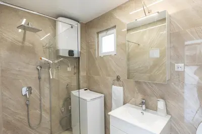 a bathroom with a shower and a toilet and a sink at DULE’S HOUSE in Belgrade