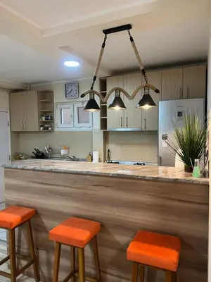 a kitchen with a bar with two stools at DULE’S HOUSE in Belgrade