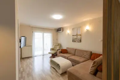 a living room with a couch and a chair at DULE’S HOUSE in Belgrade