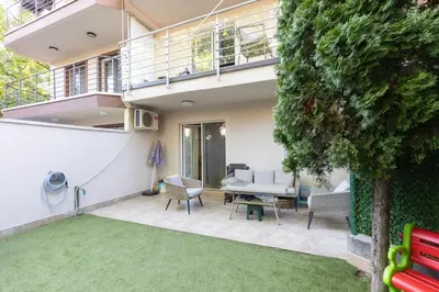 a house with a patio with a table and chairs at DULE’S HOUSE in Belgrade