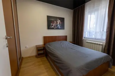a small bedroom with a bed and a window at DULE’S HOUSE in Belgrade