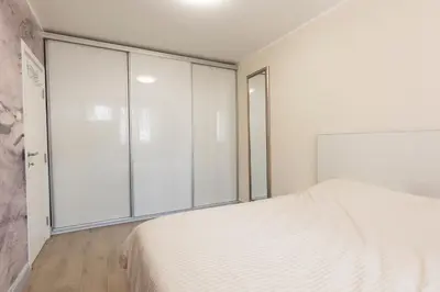 a bedroom with a bed and a large window at DULE’S HOUSE in Belgrade