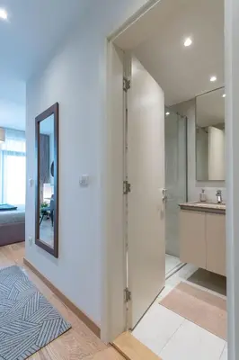 a hallway with a door leading to a kitchen at Lovely Studio Apartment - Belgrade Waterfront - Free Parking in Belgrade