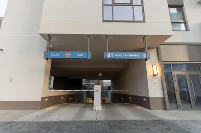 a building with a sign that reads first west entrance at Lovely Studio Apartment - Belgrade Waterfront - Free Parking in Belgrade