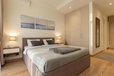 a bedroom with a large bed in a room at Lovely Studio Apartment - Belgrade Waterfront - Free Parking in Belgrade
