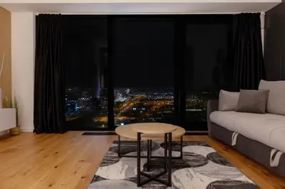 a living room with a couch and a table at In The Sky - Apartment West 65 Tower in Belgrade