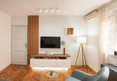 a living room with a television on a white cabinet at Dorotea Lux in Belgrade