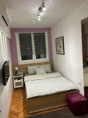 a bedroom with two beds and a window at Dorotea Lux in Belgrade