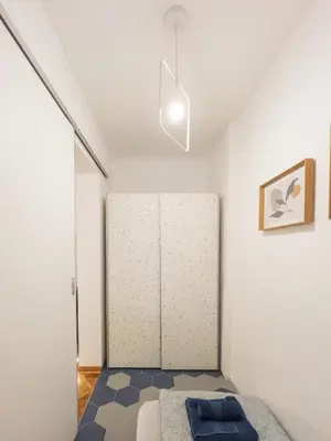 a bedroom with a bed and a closet in a room at Dorotea Lux in Belgrade