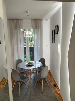 a dining room with a glass table and chairs at Dorotea Lux in Belgrade