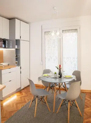 a kitchen and dining room with a table and chairs at Dorotea Lux in Belgrade