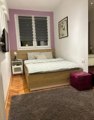 a bedroom with two beds and a window at Dorotea Lux in Belgrade