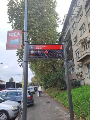 a sign on a pole on a street at Apartment Bruno NICE PLACE in Belgrade