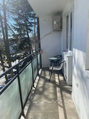 a balcony with a table and a chair on it at Apartment Bruno NICE PLACE in Belgrade