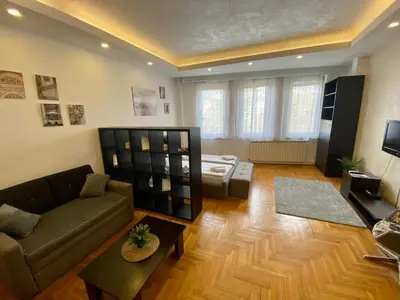a living room with a couch and a table at Apartment ARENA 28 in Belgrade