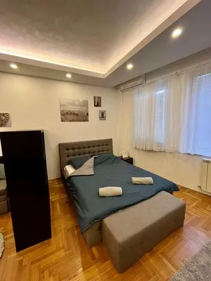 a bedroom with a large bed with two pillows on it at Apartment ARENA 28 in Belgrade
