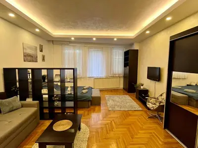 a living room with a couch and a tv at Apartment ARENA 28 in Belgrade