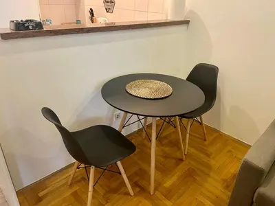 a table and two chairs in a room at Apartment ARENA 28 in Belgrade