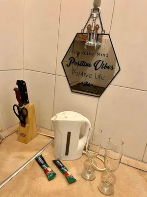 a table with wine glasses and a sign on the wall at Apartment ARENA 28 in Belgrade
