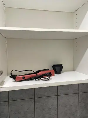 a red object sitting on a shelf in a room at Apartman Helena in Lazarevac
