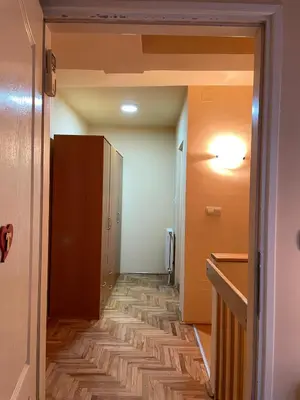 a room with a hallway with a wooden floor at Apartman Helena in Lazarevac