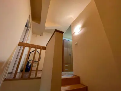 a hallway with a staircase with a light on the wall at Apartman Helena in Lazarevac