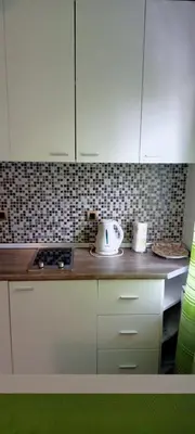 a kitchen with white cabinets and a counter top at Despot 105 in Belgrade