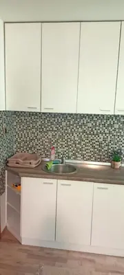 a kitchen with white cabinets and a sink at Despot 105 in Belgrade
