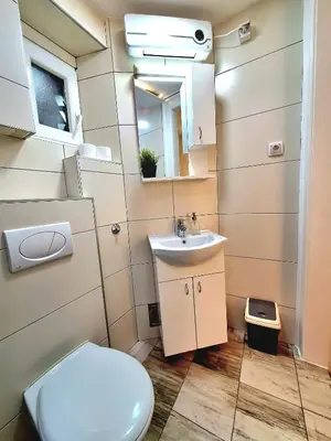 a bathroom with a toilet and a sink at GENIUS APARTMENT in Belgrade