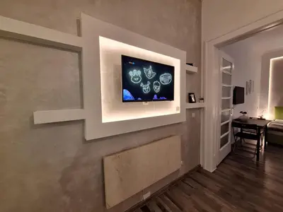 a living room with a television on a wall at GENIUS APARTMENT in Belgrade