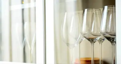 a group of wine glasses sitting next to a window at GENIUS APARTMENT in Belgrade