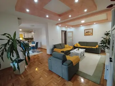 a living room with two couches and a table at Stan Ledine in Ledine