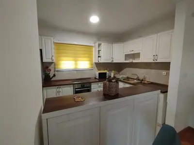 a kitchen with white cabinets and a counter top at Stan Ledine in Ledine