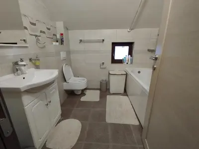 a white bathroom with a sink and a toilet at Stan Ledine in Ledine